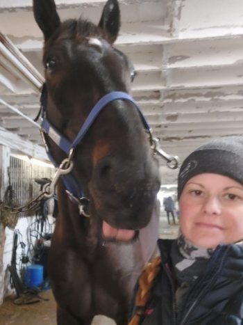 Marielle Enberg posing with one of her four horses in training. (Supplied)