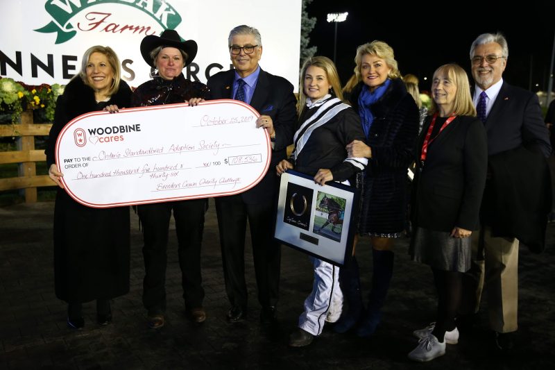 Marvin Katz (third from left) and Lynn Katz (far left) present a cheque to OSAS at the 2019 Breeders Crown Charity Challenge presentation. (New Image Media)
