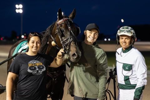 Travis Forbes and Katie Miller with Livin Ona Dream and driver J. Bradley Harris in the winner's circle on June 20, 2022 at Grand River Raceway