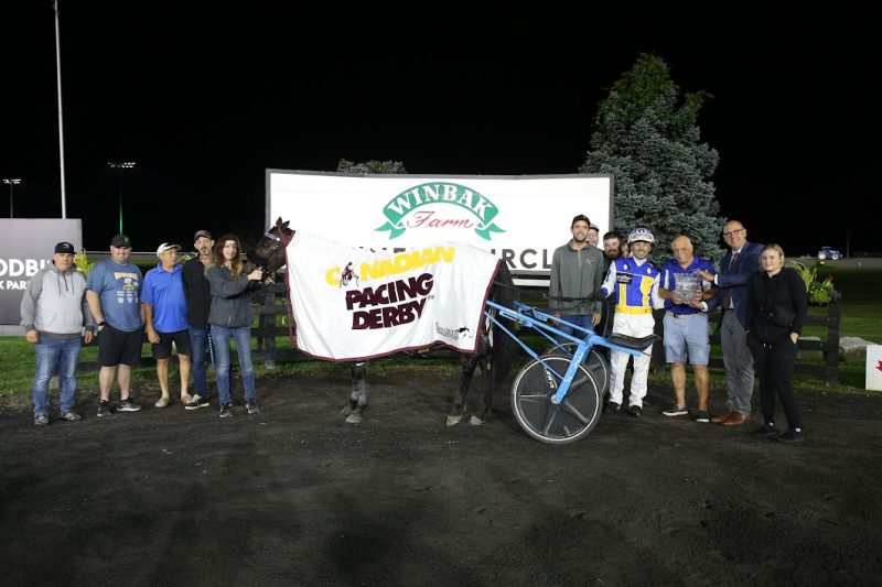 Tattoo Artist in the winner's circle for the 2023 Canadian Pacing Derby at Woodbine Mohawk Park (New Image Media)